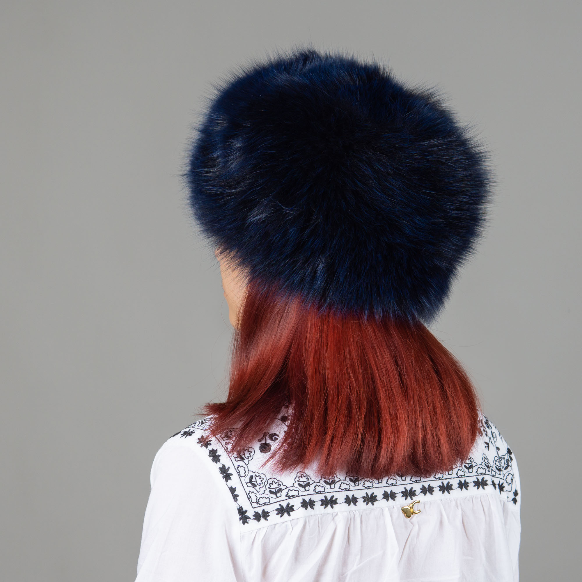Hat of fox fur in blue color