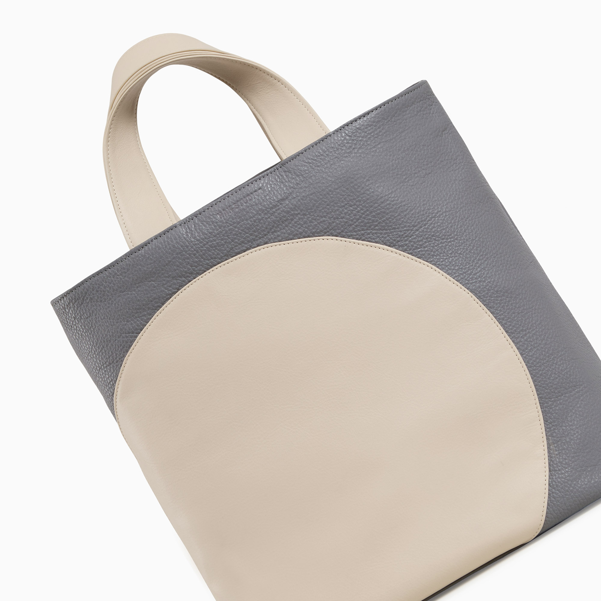 Leather handbag in beige-gray color