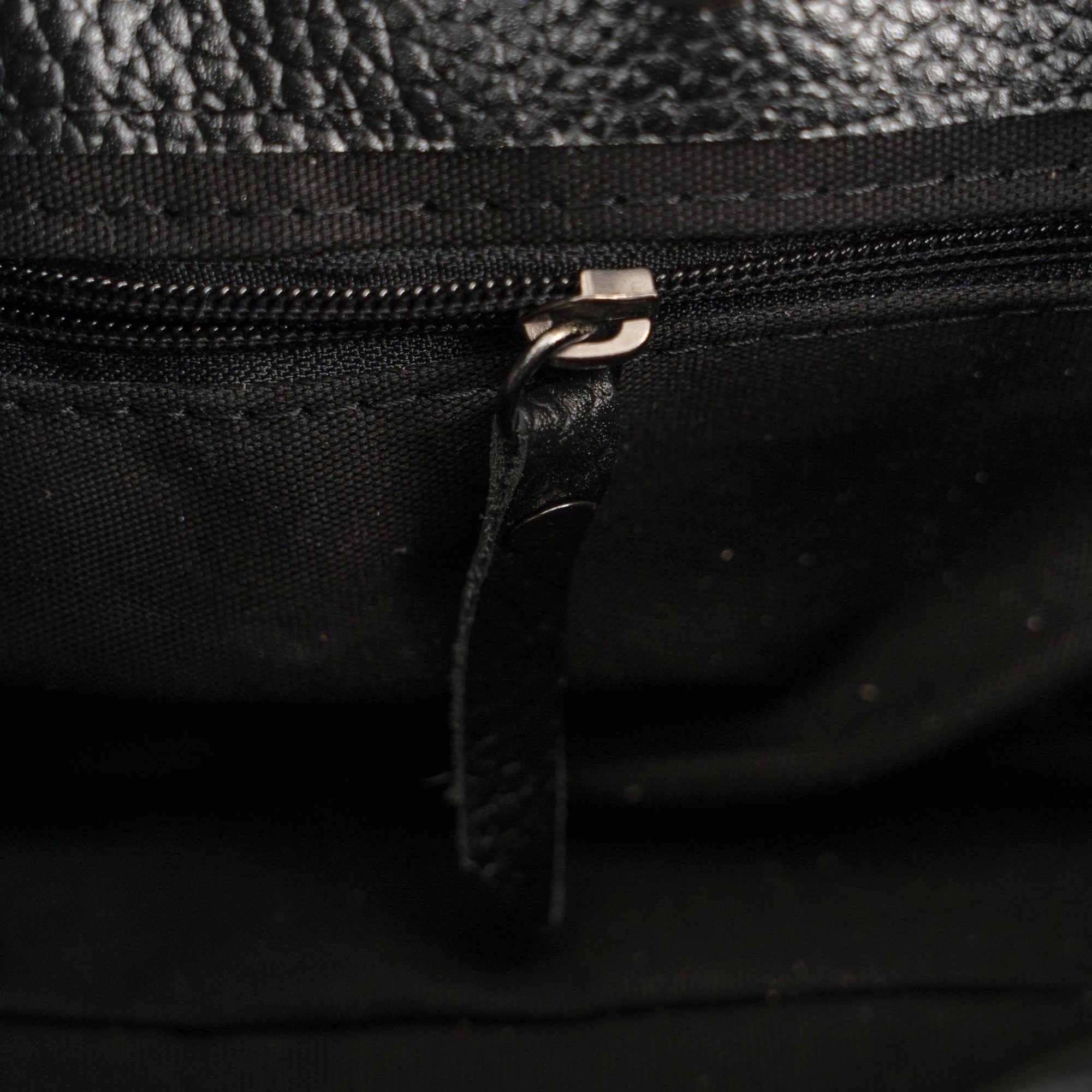 Black leather handbag with basket-embossed texture